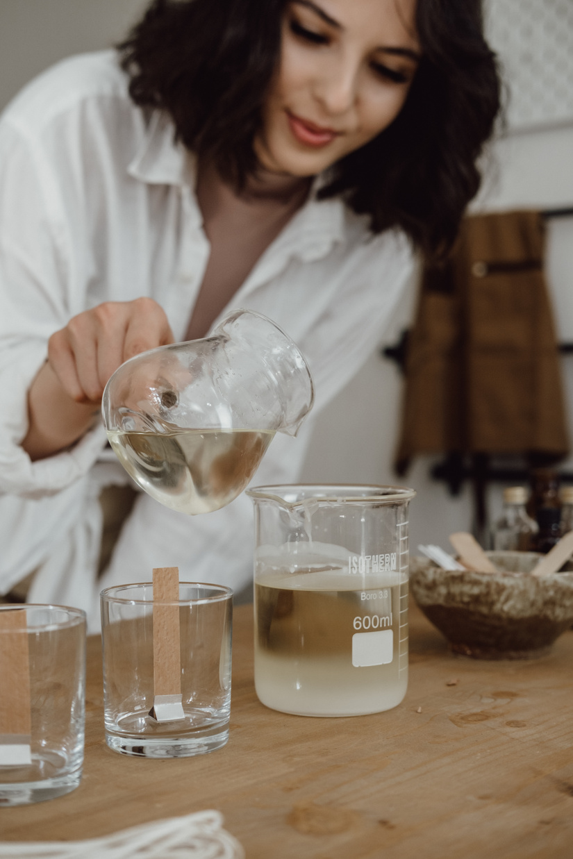 Woman Pouring Hot Wax into a Mixture