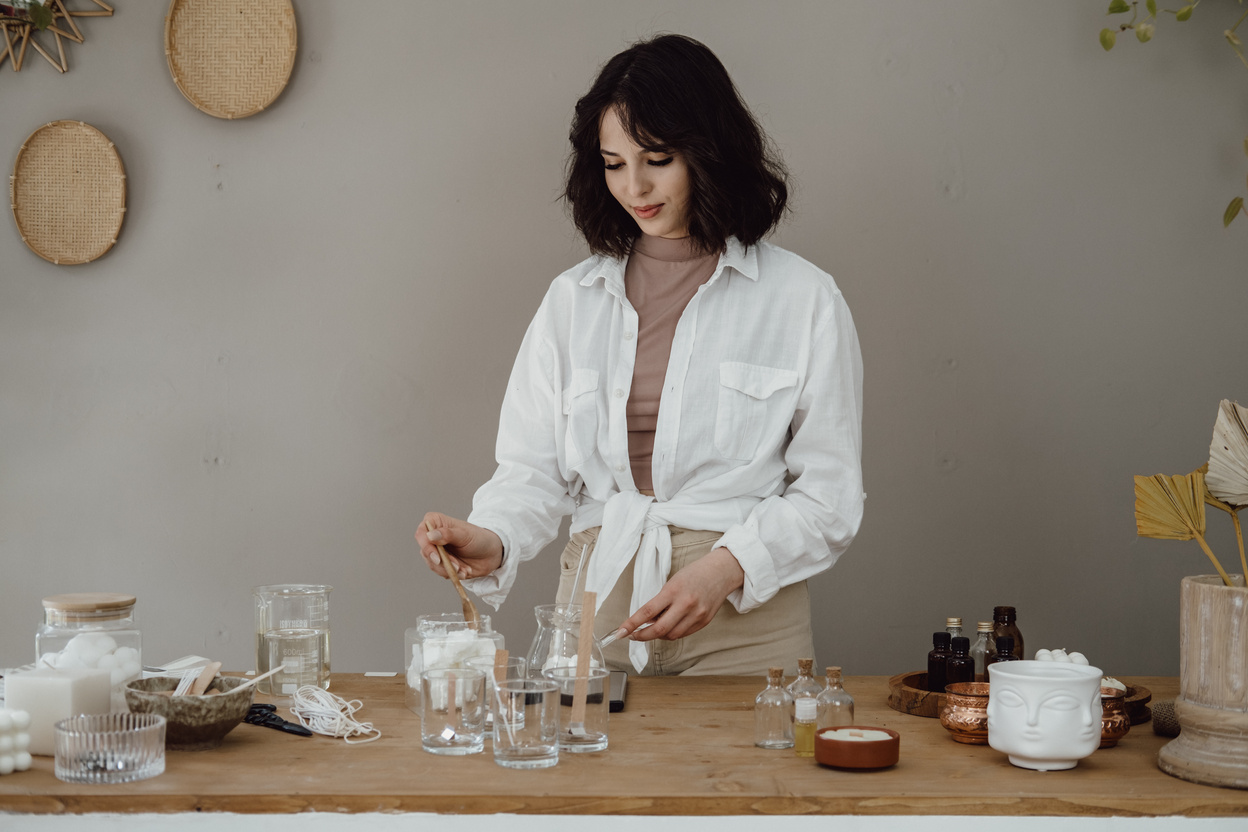 Young Woman Making a Homemade Candle Indoors