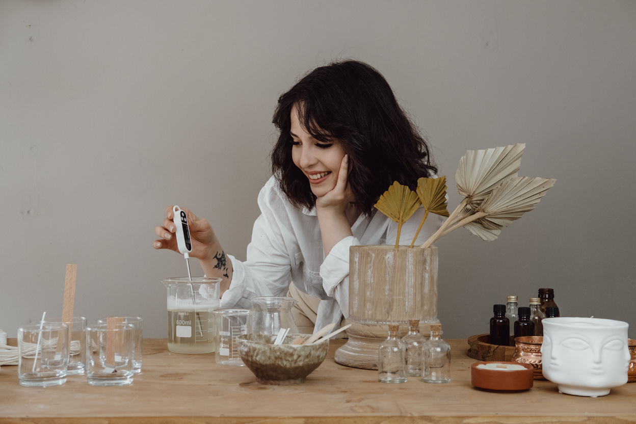 Happy Young Woman Making a Scented Candle