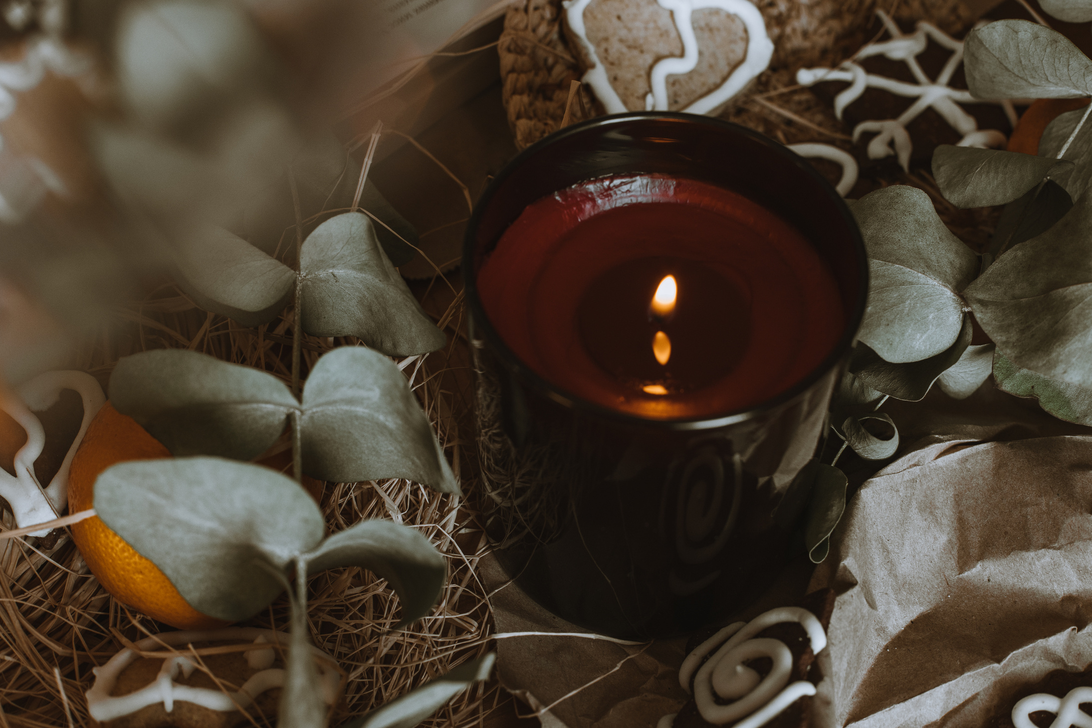 Lighted Candle in a Brown Jar