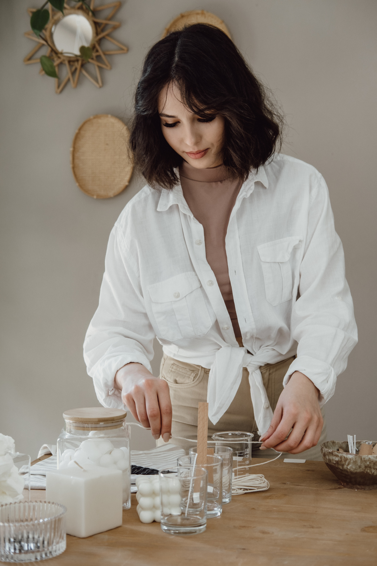 Young Woman Making a Homemade Candle Indoors
