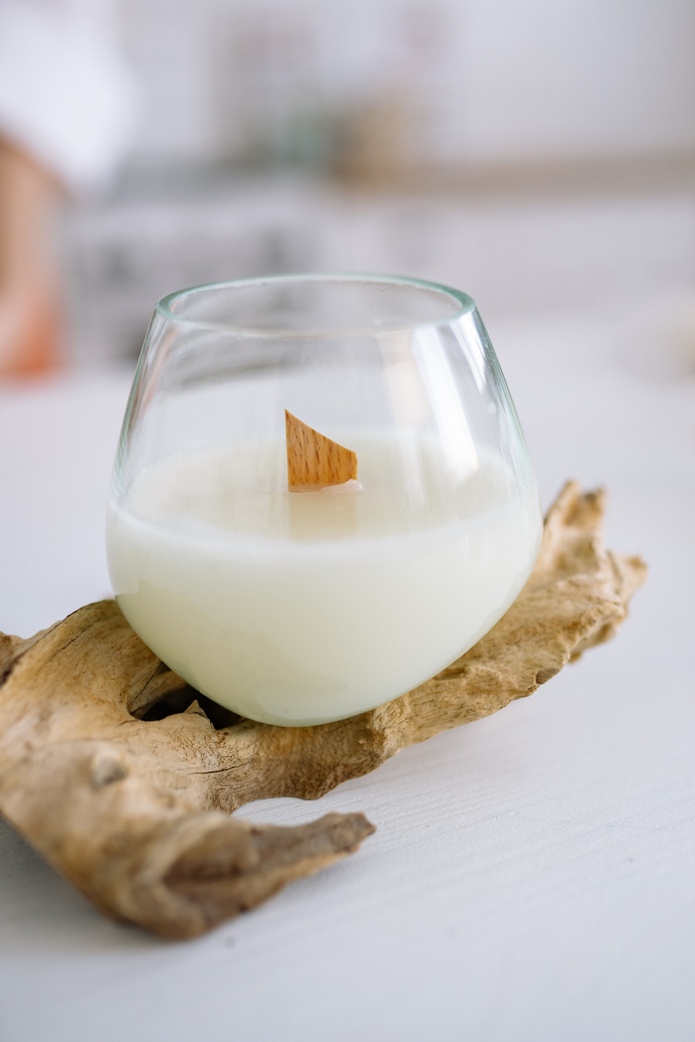 A White Candle in a Clear Glass Container